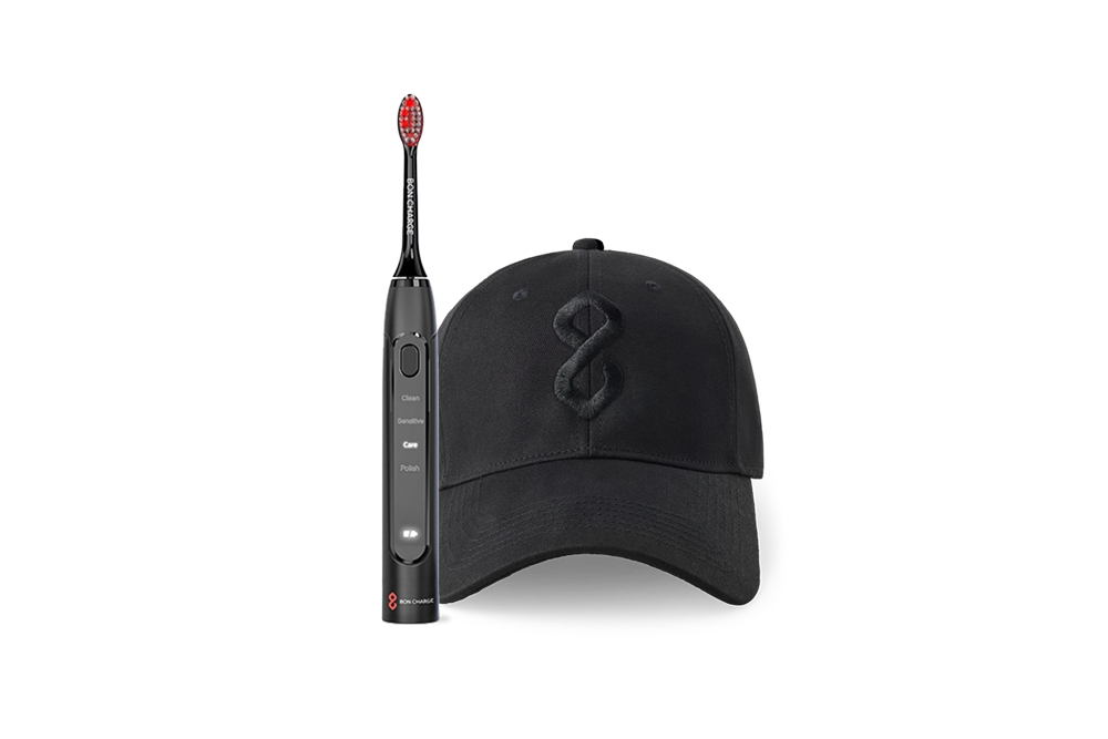 Black cap with logo and a black electric toothbrush