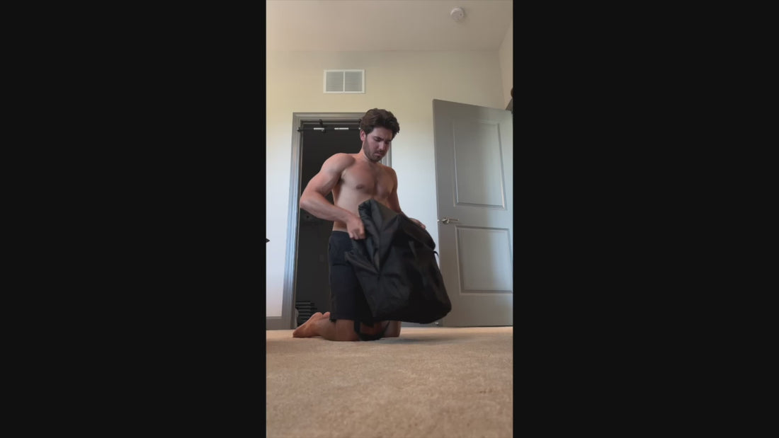 Man in sauna blanket, laying on bedroom floor 